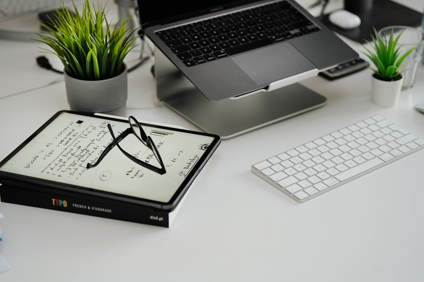 Laptop and tablet on a clean organized modern desk.